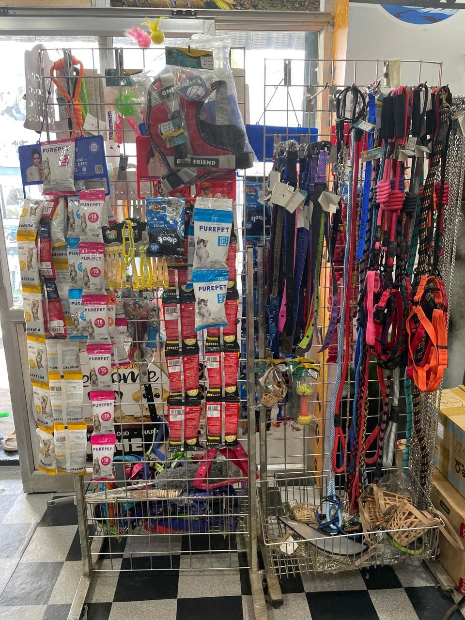 Leashes, collars and toys on the accessories rack